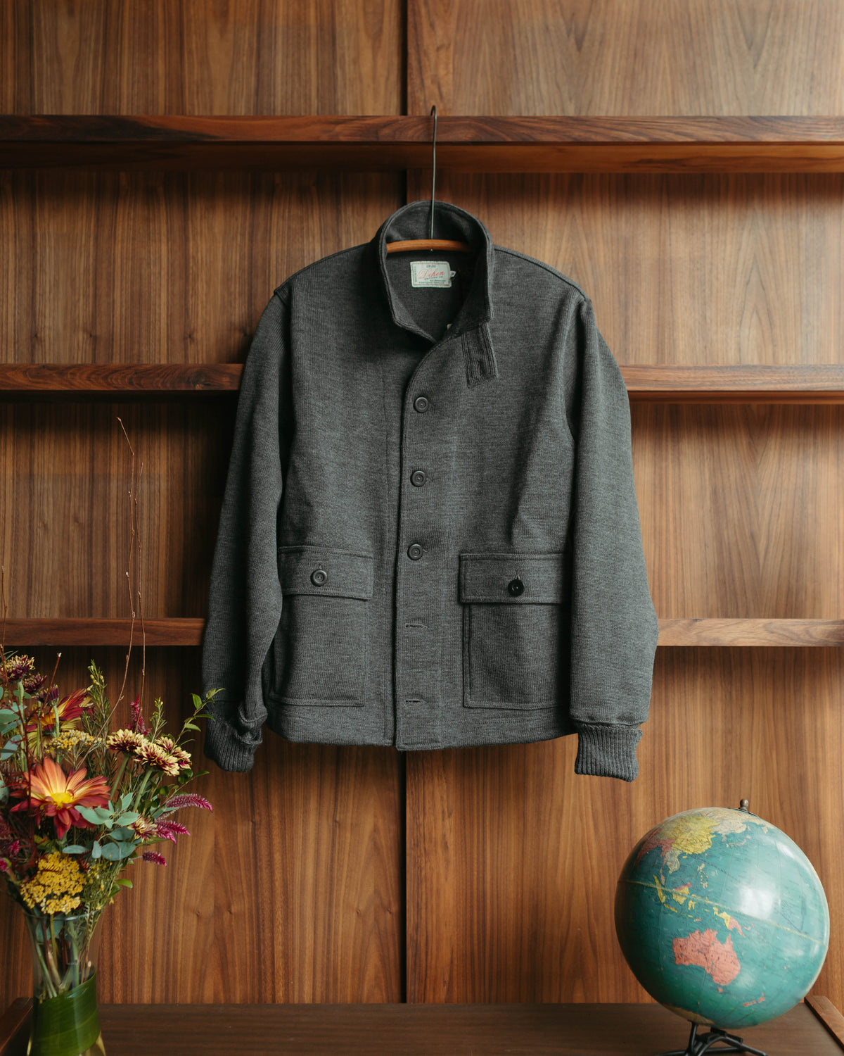 Dehen 1920 Jacket against Wooden Shelf at Fancy Groceries